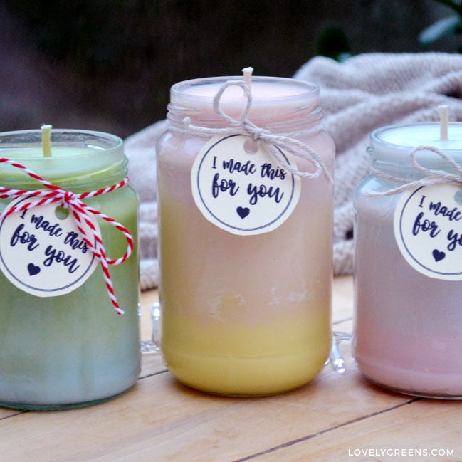 Multi-colored candles made with soy wax. There are three - one is green and blue, one is pink and yellow, and one is blue and pink.