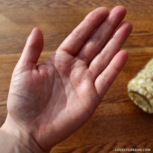 A softly glistening hand after rubbing lotion dots in. The hand does not look greasy, though.